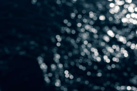 Bokeh effect.The bokeh of the lens from the surface of the water shimmering in the sunlight. The...