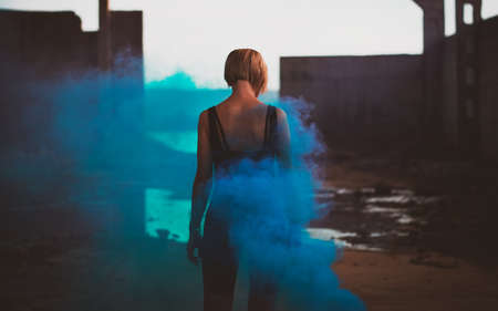 Attractive woman with a colorful smoke grenade bombの写真素材