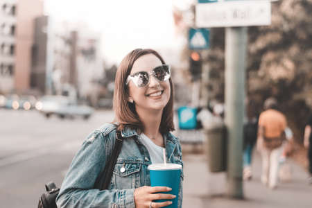 Fashionable girl laughing to camera while resting in summer dayの写真素材