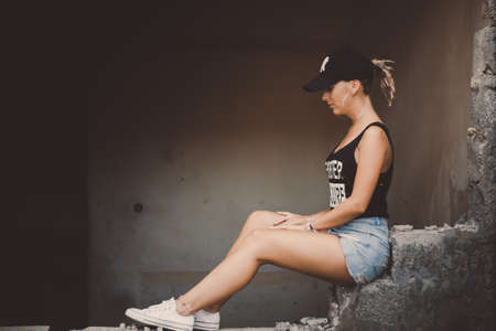 A girl sitting in the building in ruinsの写真素材