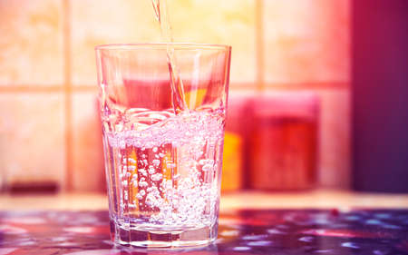 Glass of pure water on kitchen tableの写真素材