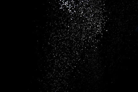Realistic falling snowflakes. Isolated on black background.の写真素材