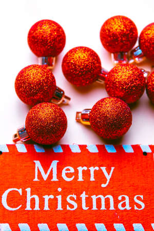 banner on white background surrounded by red balloons on which he writes merry christmasの写真素材