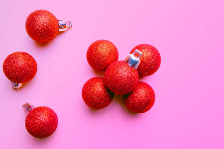 red christmas balloons with glitter on pink backgroundの写真素材