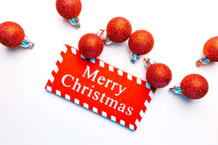 banner on white background surrounded by red balloons on which writes merry christmasの写真素材