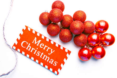 banner on white background surrounded by red balloons on which writes merry christmasの写真素材