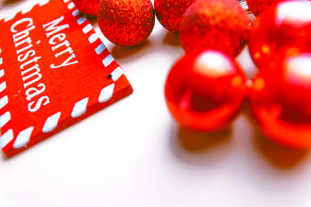banner on white background surrounded by red balloons on which writes merry christmasの写真素材