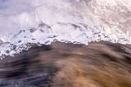 texture of ice above a frozen riverの写真素材