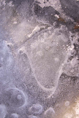 texture of ice above a frozen riverの写真素材