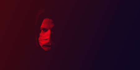 coronavirus, a man in a mask on a dark background. Title about the outbreak of the corona virus , illness. Epidemicの写真素材