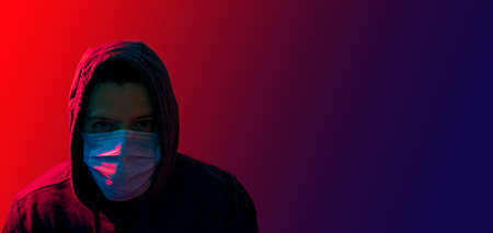 coronavirus, a man in a mask on a dark background. Title about the outbreak of the corona virus,...