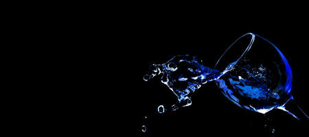 Pour water into glass on black background.の写真素材