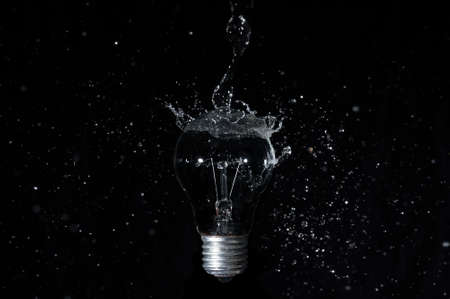 Isolated Led Light Water Splash on black background.の写真素材