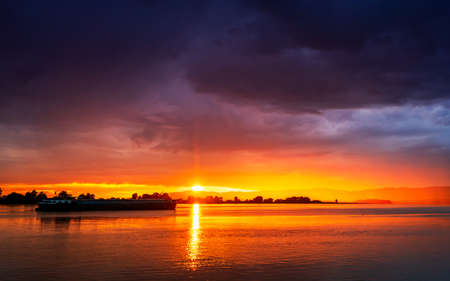Dramatic stormy dark cloudy sky, natural photo backgroundの写真素材
