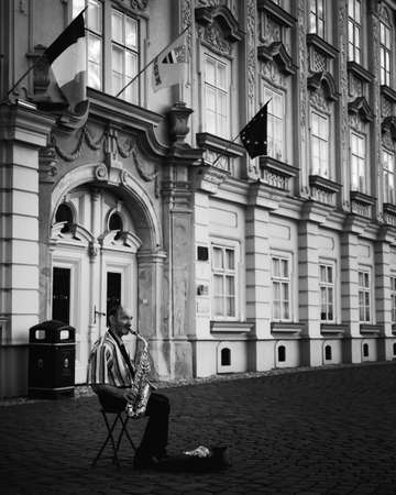 Black and white picture of a man playing the saxophone on the street. Timisoara, Romania-JUNE 5, 2020のeditorial素材