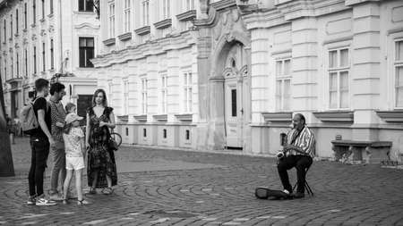 Black and white picture of a man playing the saxophone on the street. Timisoara, Romania-JUNE 5, 2020のeditorial素材