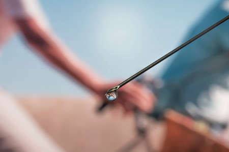 Syringe needle with a drop of serum on top. Blurred background that is reflected in the serum drop.の写真素材