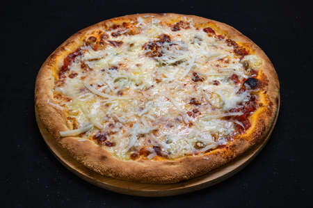 Pizza quatro formaggi with tomato sauce and 4 kinds of cheese on a black background.の写真素材