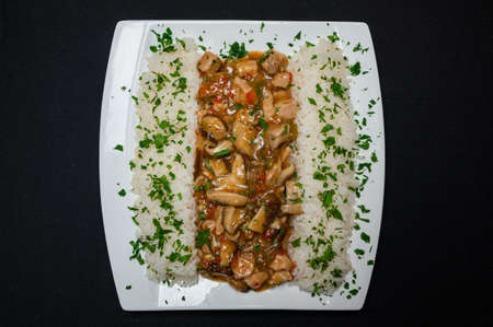 Pizza with tomato sauce, salami, pork ham, olives, peppers and mushrooms on a black background.の写真素材