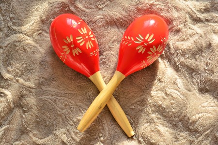 Couple of bright red wooden maracas