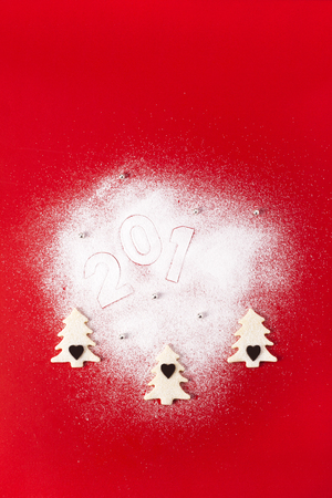Christmas and new year gingerbread cookies on red backgroundの写真素材