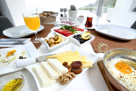 Rich and delicious Turkish breakfast on white wood tableの写真素材