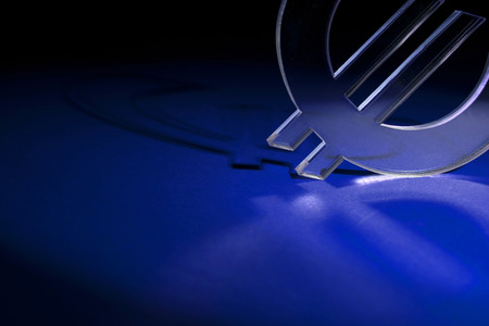 Currency unit on the red carpet with shadowの写真素材