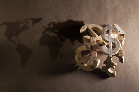 Wooden economy and currency units on craft backgroundの写真素材