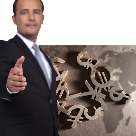 Businessman reach out a hand to deal front of the worlds money iconsの写真素材