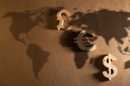 Wooden economy and currency unit on a craft backgroundの写真素材