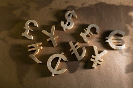 Wooden economy and currency units on craft backgroundの写真素材