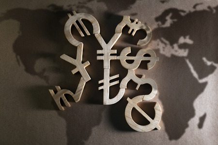 Wooden economy and currency units on craft backgroundの写真素材