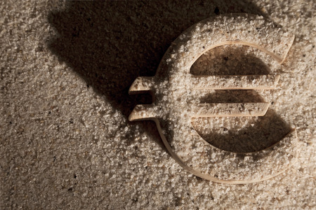 Wooden economy and currency unit in sand with shodowの写真素材