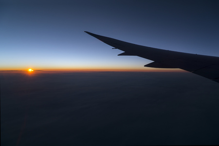 Sunrising panorama from a plane window early morningの写真素材