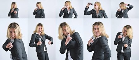 Happy businesswoman is singing with microphoneの写真素材