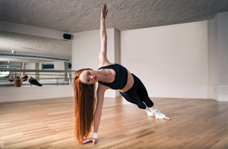 young woman doing stretching or ballet exercisesの写真素材