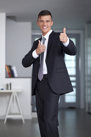 Portrait of a successful young Businessman posing in officeの写真素材