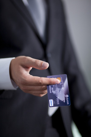 Businessman holding an credit cardの写真素材