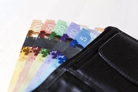 Canadian Dollars in a open black leather walletの写真素材