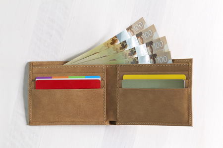 Canadian Dollars and credit cards in mustard coloured leather walletの写真素材