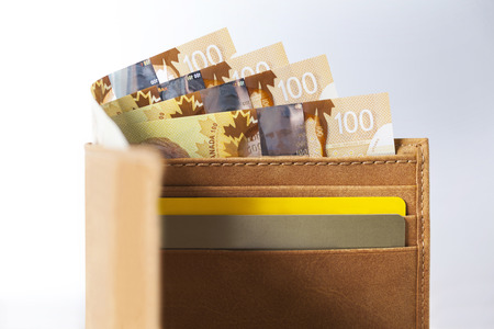Canadian Dollars and credit cards in mustard coloured leather walletの写真素材
