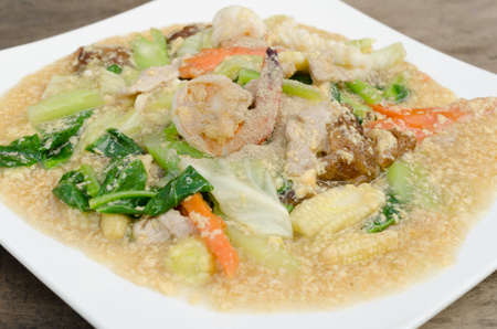 Fried noodle with pork and kale soaked in gravyの写真素材