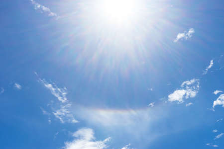 beam from the sun, causing a bright rainbow in the skyの写真素材