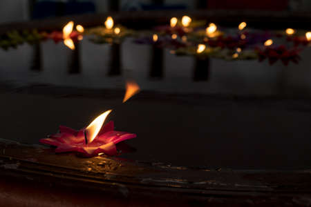 Candles floating in the waterの写真素材