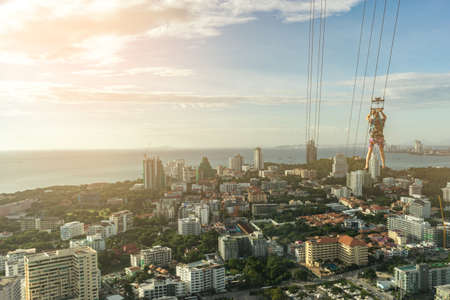 Man rappelling down from a skyscraper with funの写真素材