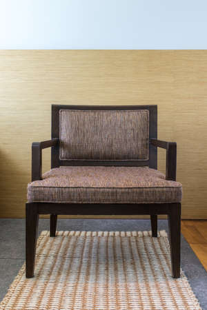 chair on carpet with wood wall backの写真素材