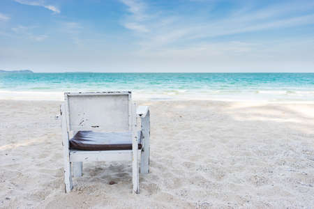 old chair on white sand beach