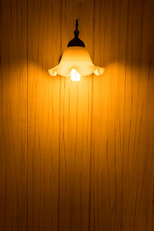 yellow bulb light with wall woodの写真素材