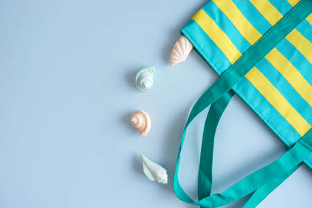 top veiw of travel sea concept have straw hat, nylon bag and soap shell on blue background, flat lay styleの写真素材