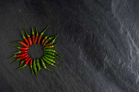 fresh red chili and green chili on stone background. hot and spicy in thailand. flat lay styleの写真素材